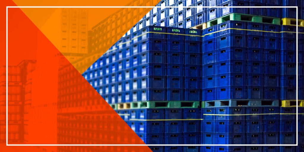 blue crates stacked on pallets in a cold storage facility